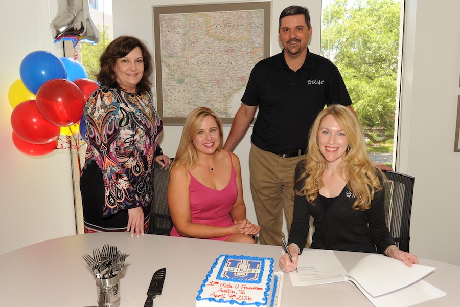 1st IKids U Franchise Owners Signing Documents And Celebrating